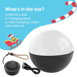 3D holographic video memory ball glowing on wooden table with festive Christmas tree lights in background
